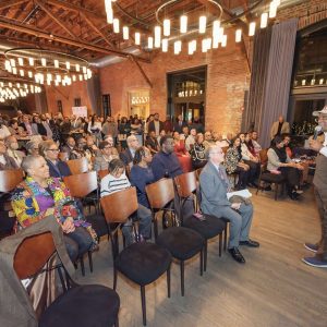 Man speaking to seated audience