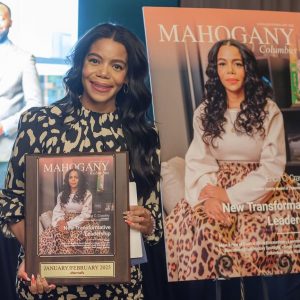 Woman posing with award and poster