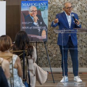 Man of the Year speaking at podium