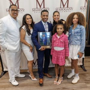 Group posing in front of branded backdrop